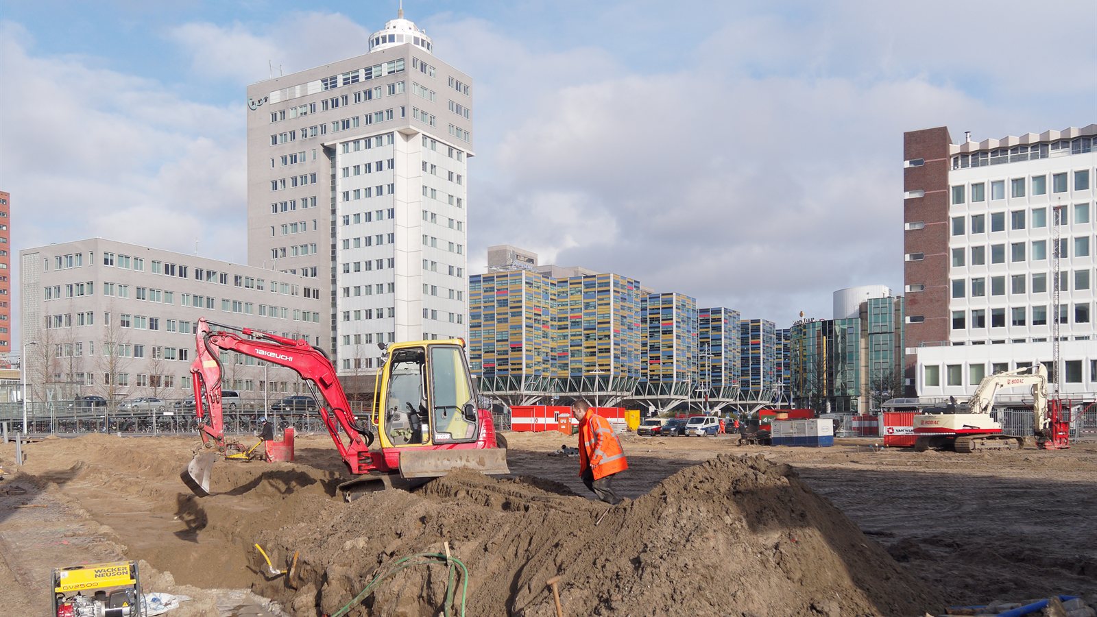 Excavator and materials on an urban building site